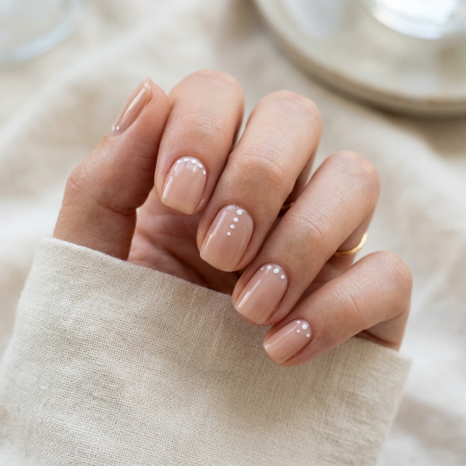 Nude nails with dot accent